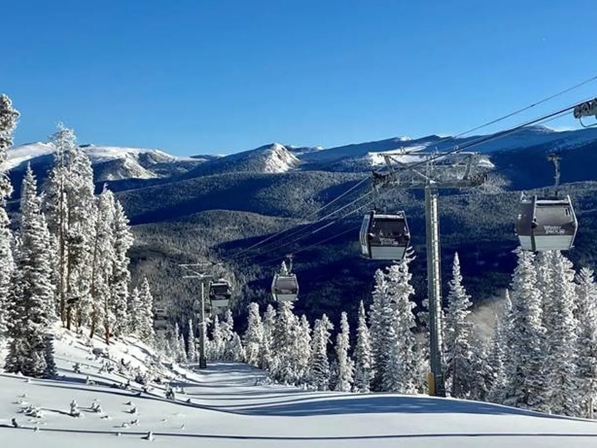Snow-covered slopes and ski lift gondolas set against distant mountains and evergreen trees, capturing the essence of winter sports and outdoor activities. The scene is lively and adventurous, embodying the region’s recreational spirit.